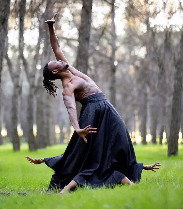 Two professional dancers performing together in middle of forest