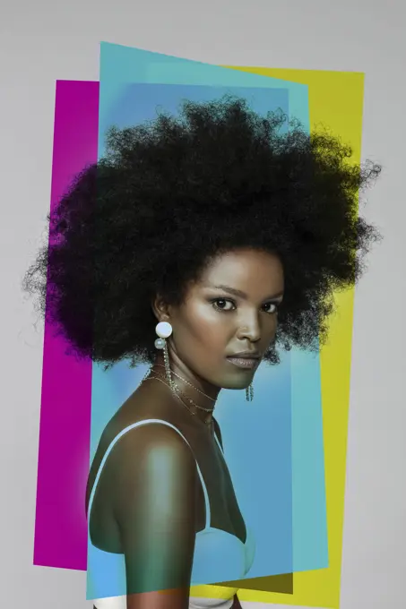 Attractive Afro woman with primary colors against white background