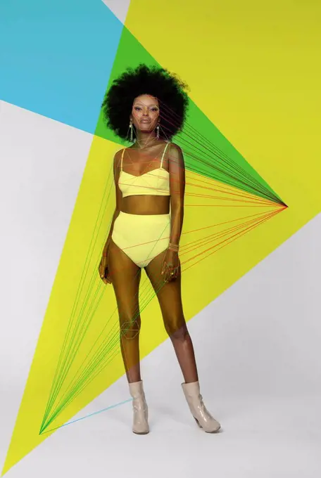 Afro woman with facial recognition laser beams standing against white background