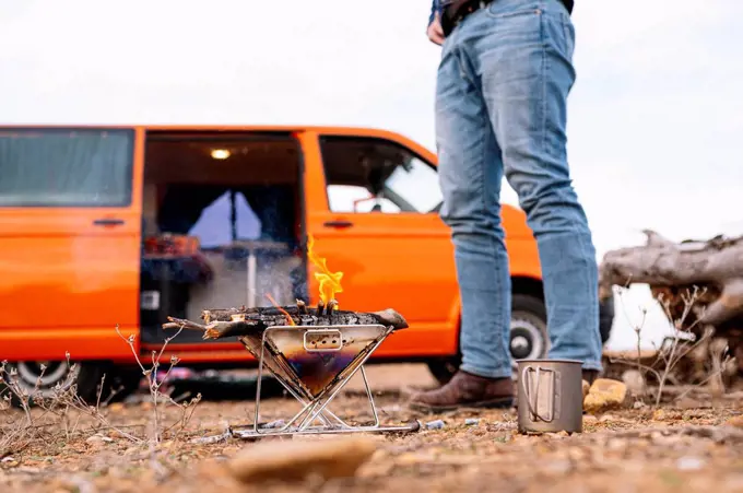 Man standing in front of camping stove