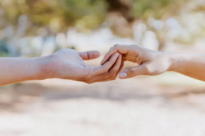 Boyfriend holding hand of girlfriend