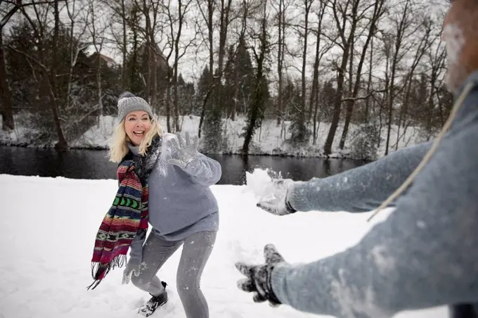 Senior couple playing with snow during winter