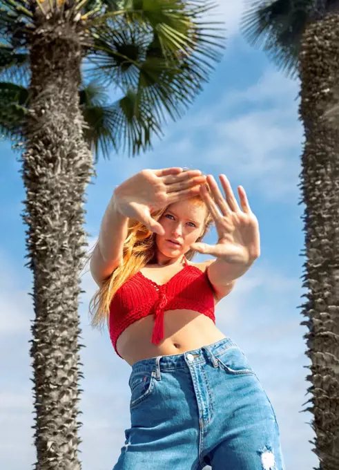 Young woman gesturing during sunny day