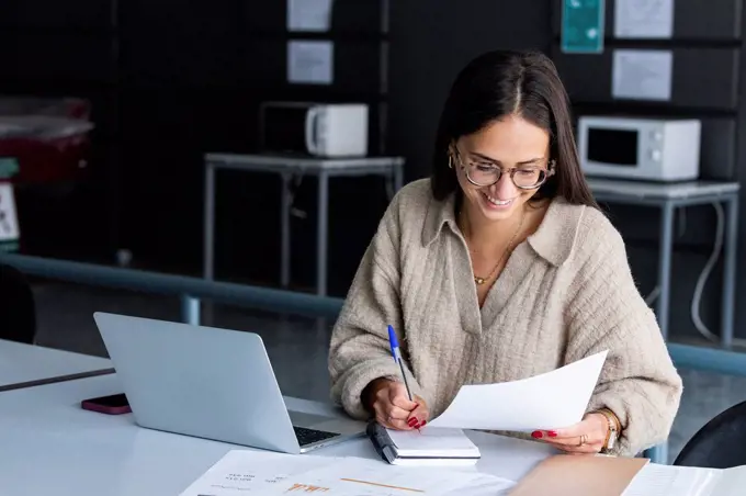 Smiling businesswoman working at office