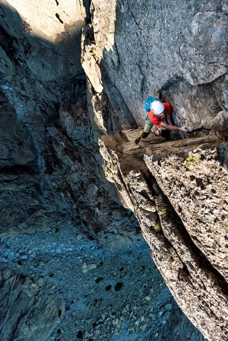 Caucasian man climbing rock mountains