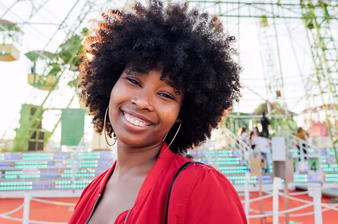 Young woman smiling in amusement park