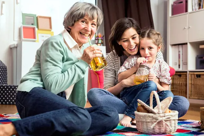 Multi-generation family playing picnic in nursery