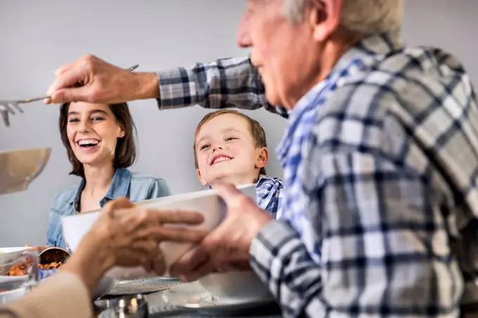 Multi-generation family sharing food with each other at home