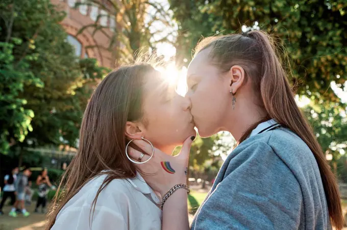 Young couple kissing on mouth at park