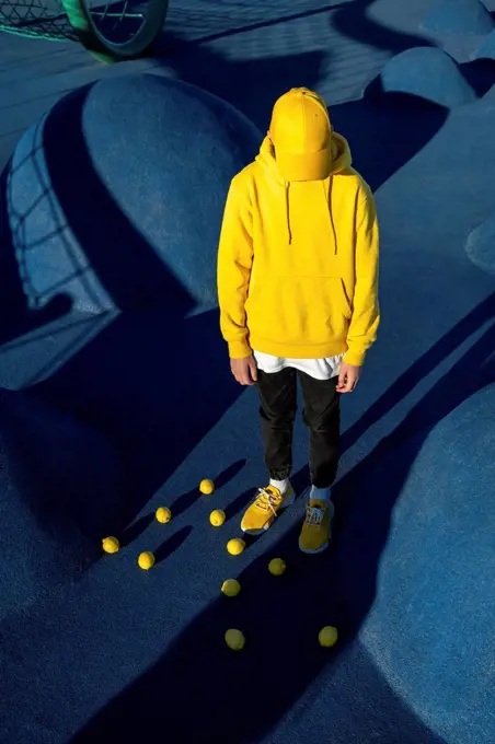 Boy standing amidst lemons at skateboard park