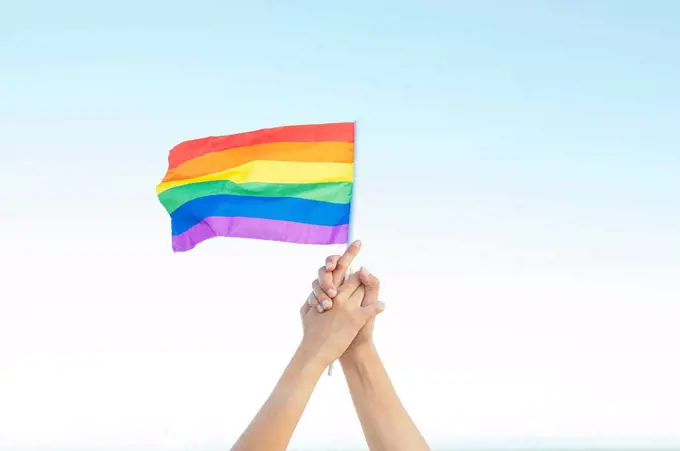 Lesbian couple holding rainbow flag