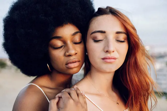 Young lesbian couple with eyes closed