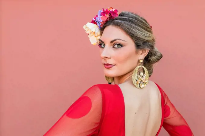 Young dancer wearing flowers with traditional flamenco dress