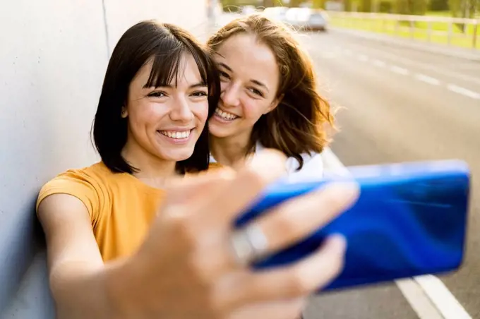 Lesbian couple taking selfie through mobile phone