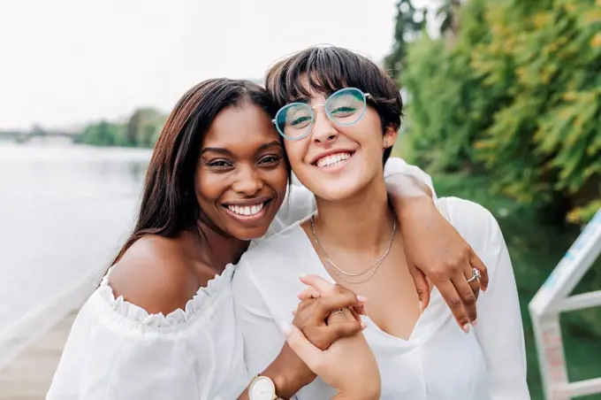 Cheerful female friends at lakeshore