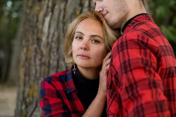 Blond mature woman embracing boyfriend