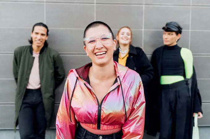 Happy woman standing with friends in background