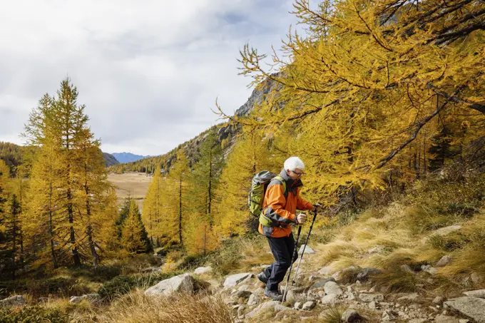 Senior backpacker hiking on mountain