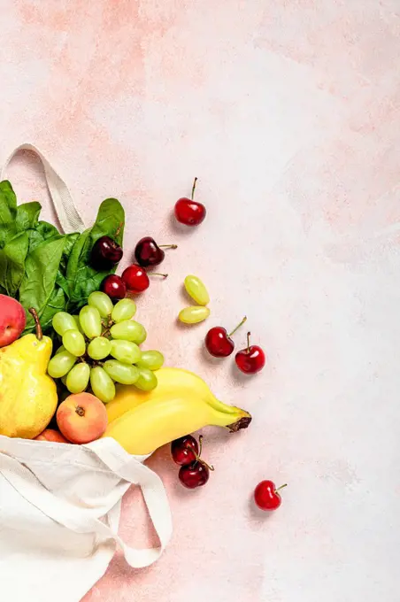 Studio shot of reusable bag filled with ripe fruits and vegetables