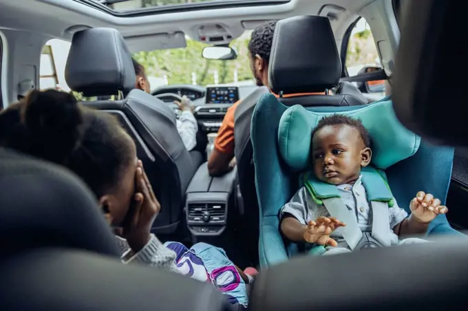 Family in car on road trip