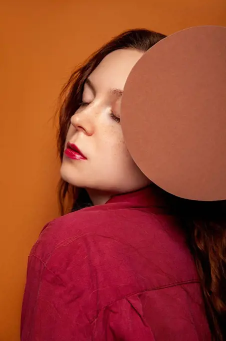 Beautiful woman posing with circle in studio