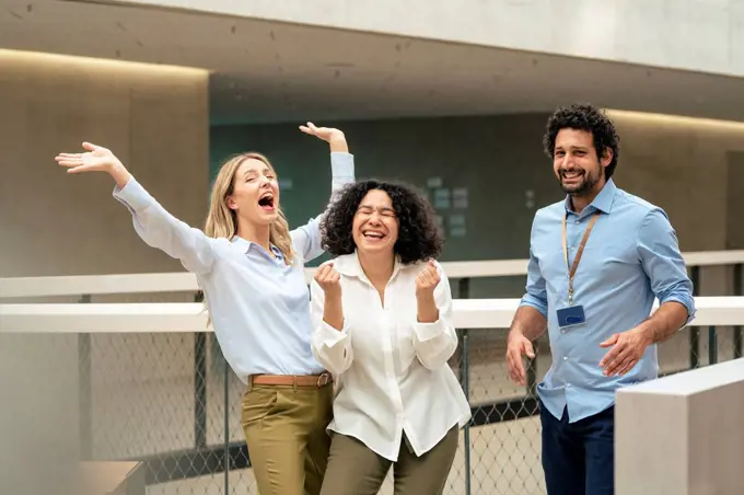 Cheerful business colleagues enjoying in corridor