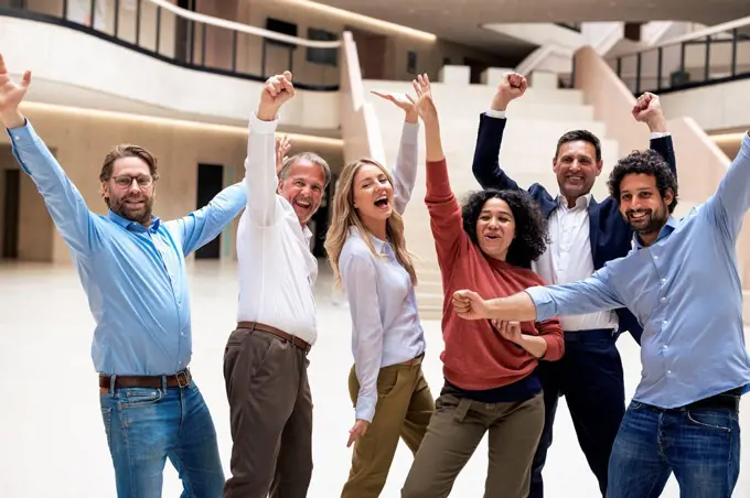 Carefree business colleagues dancing in lobby