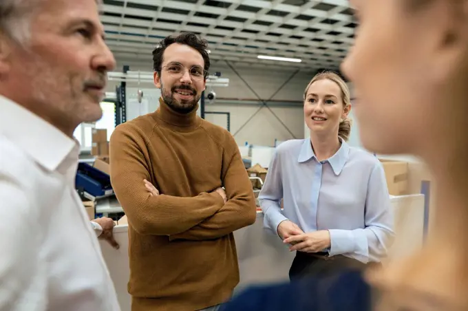 Smiling business colleagues discussing at industry