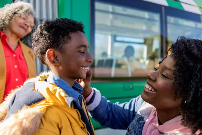 Happy multi-generation family at railroad station