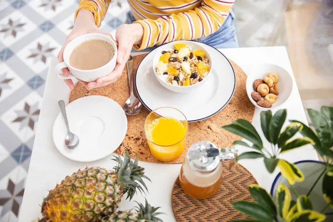 Woman having healthy breakfast at table