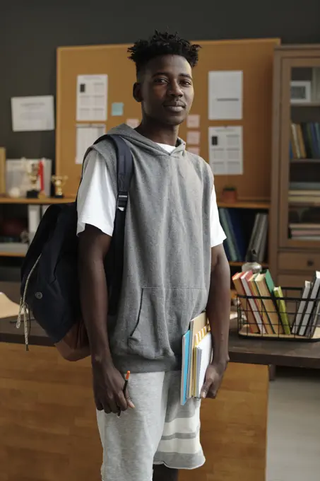 Student standing with backpack in university office