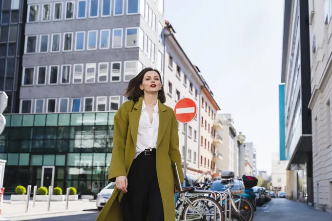 Fashionable businesswoman walking in city