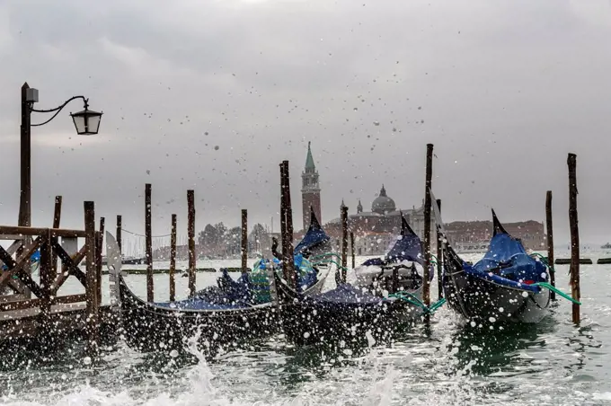 Italy, Venice, Gondolas and church San Giorgio Maggiore at high watermark