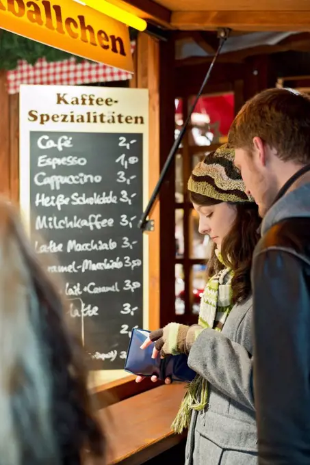 Germany, Berlin, young couple at Christmas market