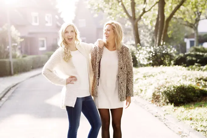 Two smiling blond women having fun together