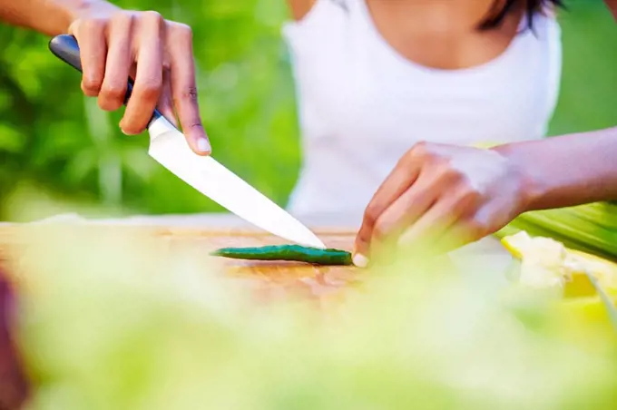 Young woman preparing healthy meal in garden