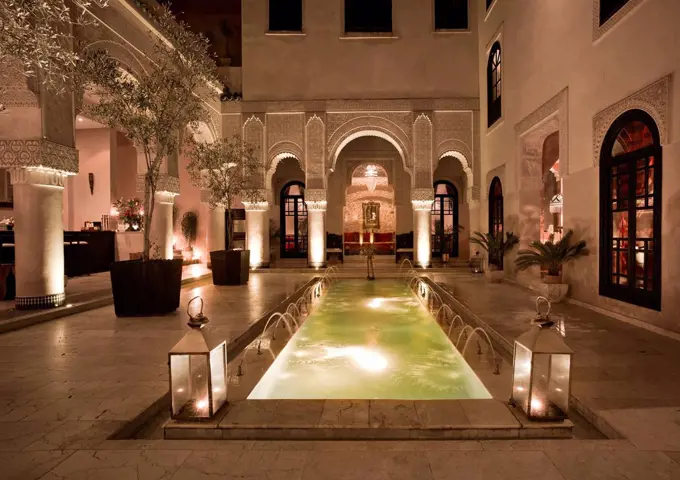 Morocco, Fes, Hotel Riad Fes, courtyard with lightened pool by night