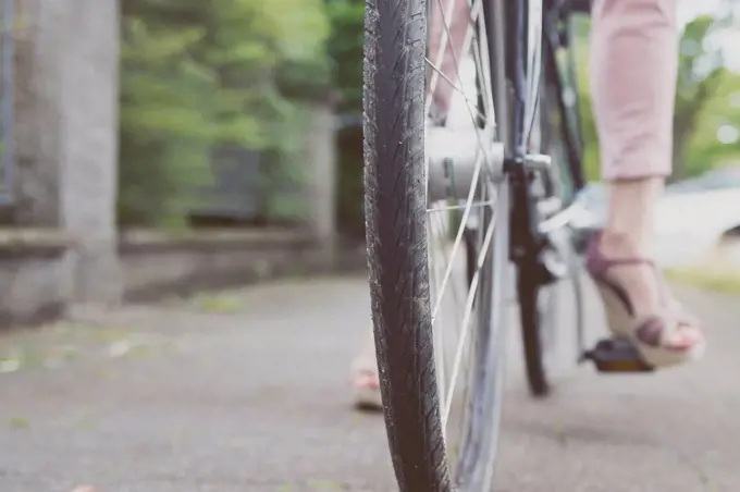 Close-up of woman with wedges on bicycle