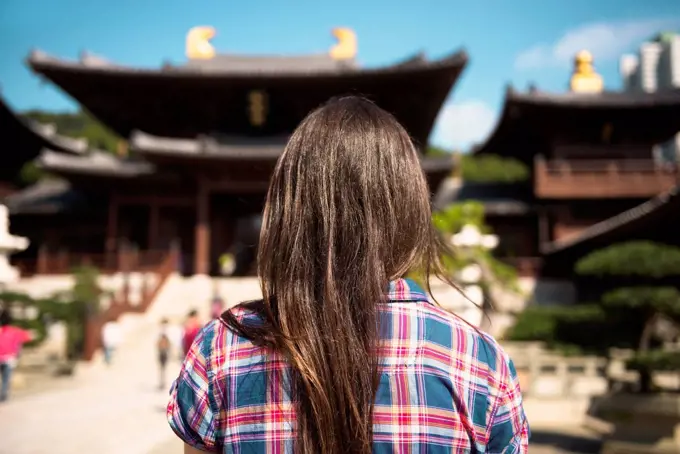 China, Hong Kong, Kowloon, back view of woman visiting Chi Lin nunnery