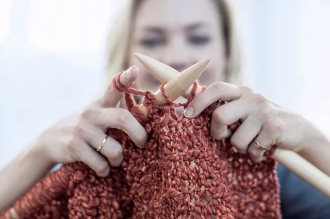 Close-up of woman knitting a blanket