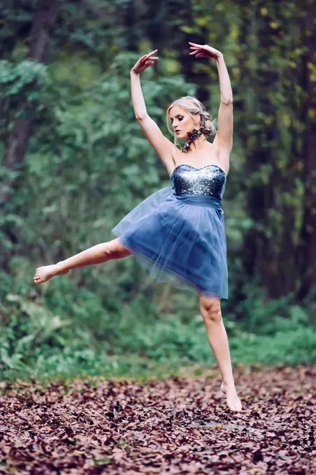 Austria, female dancer in the wood, jumping