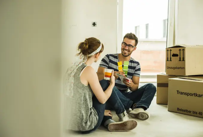 Couple moving house looking at colour samples