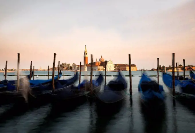 Italy, Venice, gondolas in front of San Giorgio Maggiore at dusk