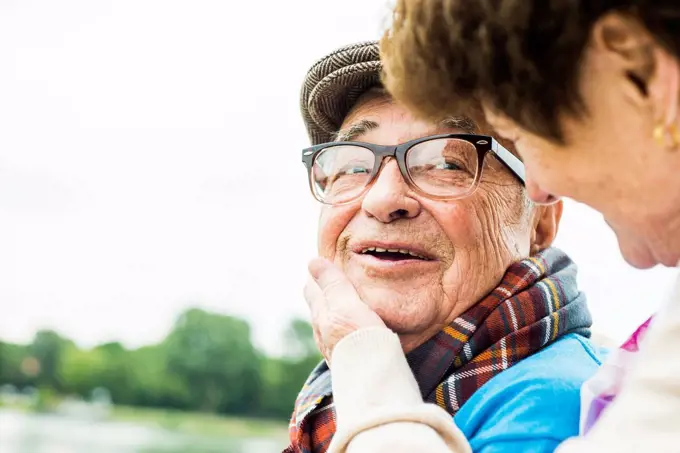 Portrait of happy senior man face to face with his wife