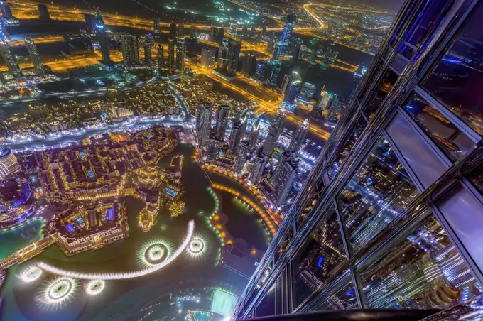 United Arab Emirates, Dubai, Fountain in the Burj Khalifa Lake with Souk Al Bahar seen from the Burj Khalifa at night