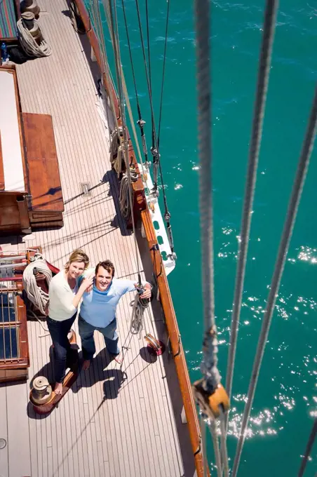 Mature couple on deck of a sailing ship