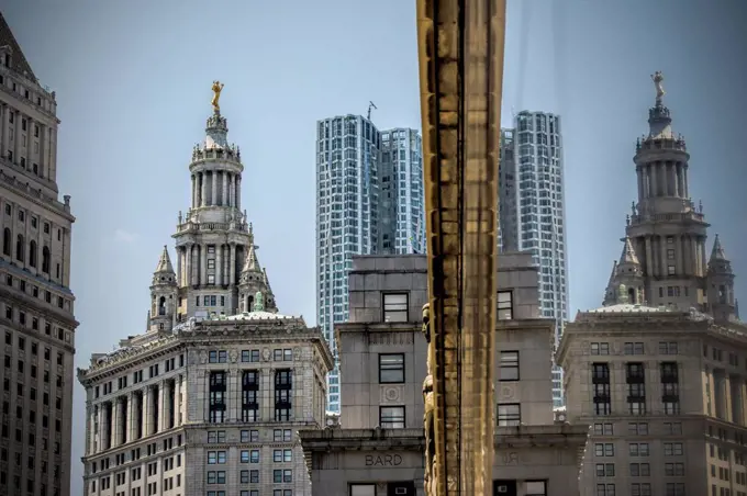 USA, New York City, Highrise building mirrored in glass facade