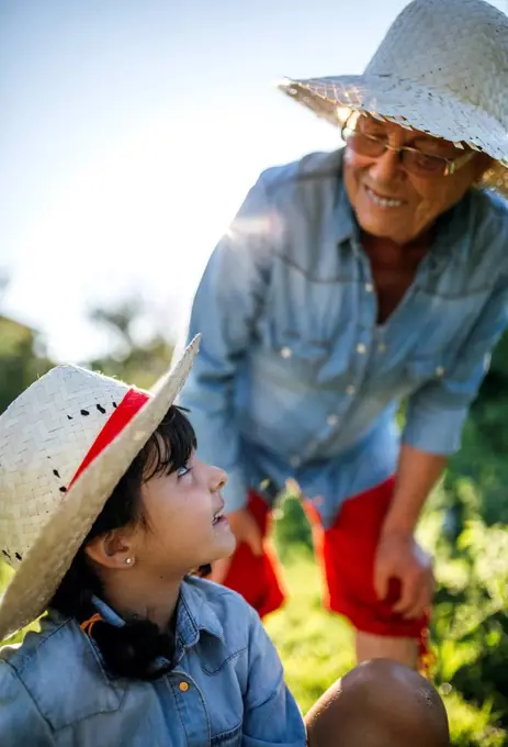 Senior woman and her granddaughter in the garden