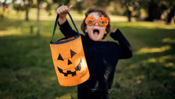 Masquerade little girl holding halloween lantern