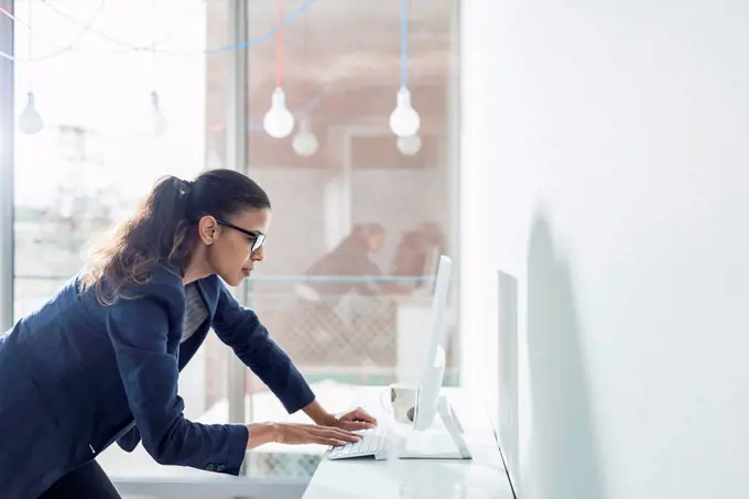 Young woman in office working on computer